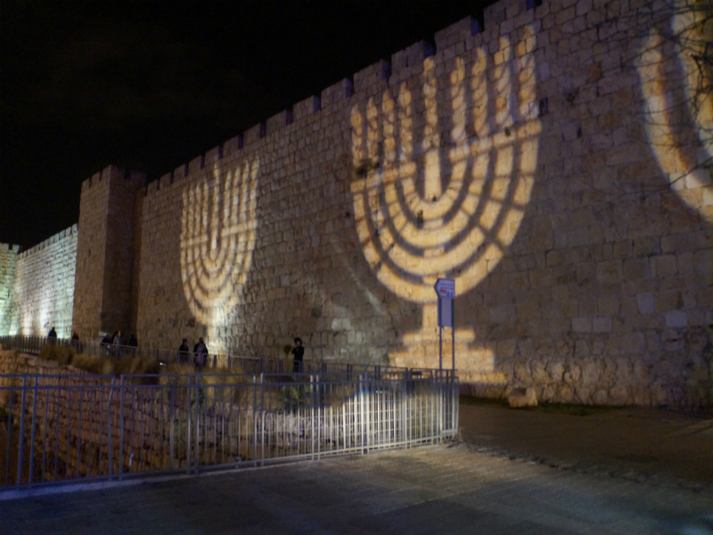 A Hanukkiah is projected on the Old City walls of Jerusalem in celebration of Hannukah